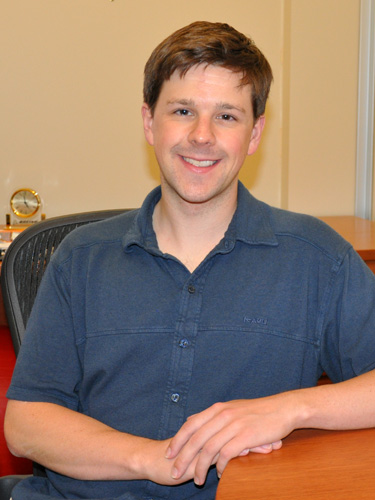 David Gleich seated in his office wearing a blue shirt