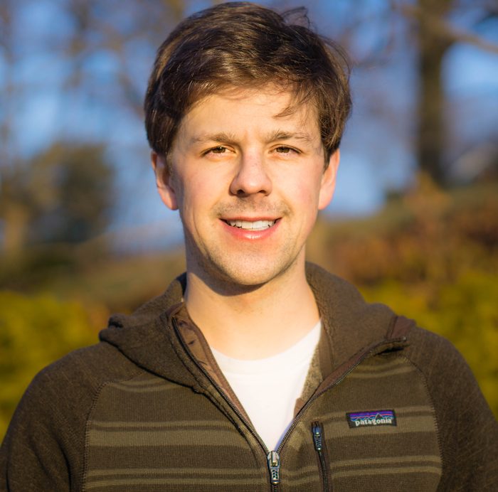 David Gleich outdoors in winter sun wearing a striped fleece jacket